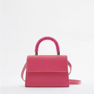 Pink mini bag with beaded handle and strap